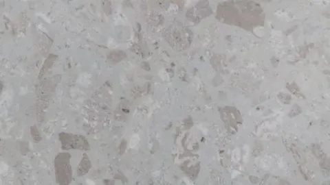 Breccia Chiara engineered marble: pale grey ground with soft-edged mushroom brown and white fragments