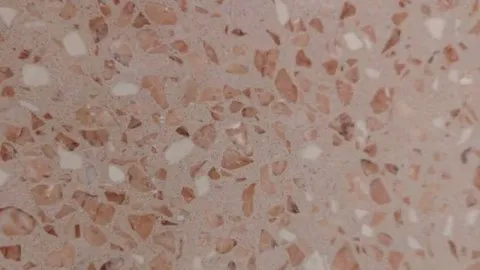 Breccia Rosa engineered marble: dusty rose ground packed with salmon and terracotta-pink fragments and white chips