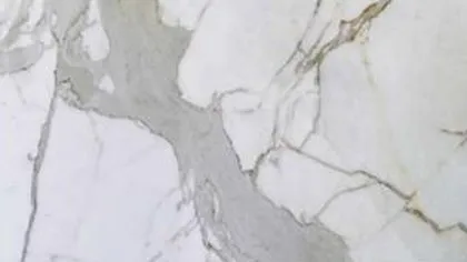 Calacatta marble: wide grey veins with thin gold edges on clean white
