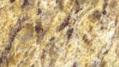 Giallo Ornamental granite slab: golden crystals with diagonal burgundy-brown streaks