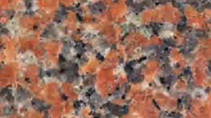 Maple Red granite slab: orange-red crystals among grey and black grains
