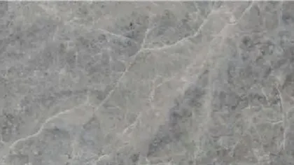 Maya Grey marble: cool blue-grey ground with hazy darker clouds and fine pale diagonal veins