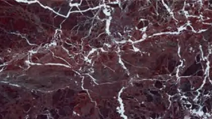 Rosso Levanto marble: wine red and dark aubergine ground split by branching white veins