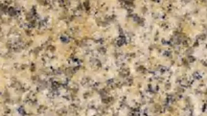 Rusty Yellow granite slab: rust-gold patches and blue-grey crystals on pale yellow-beige