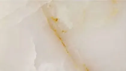 White Onyx slab: milky white with a thin gold vein