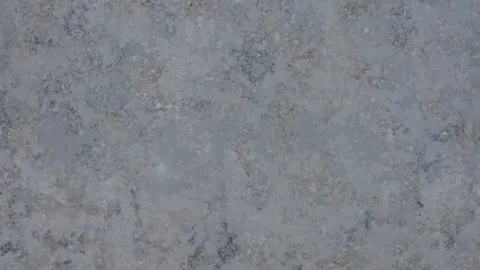 Ardesia Blu quartz slab: mottled blue-grey slate look with rust-brown specks