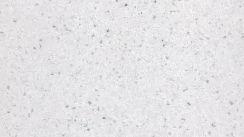 Bianco Grano quartz slab: off-white evenly dotted with small grey flecks