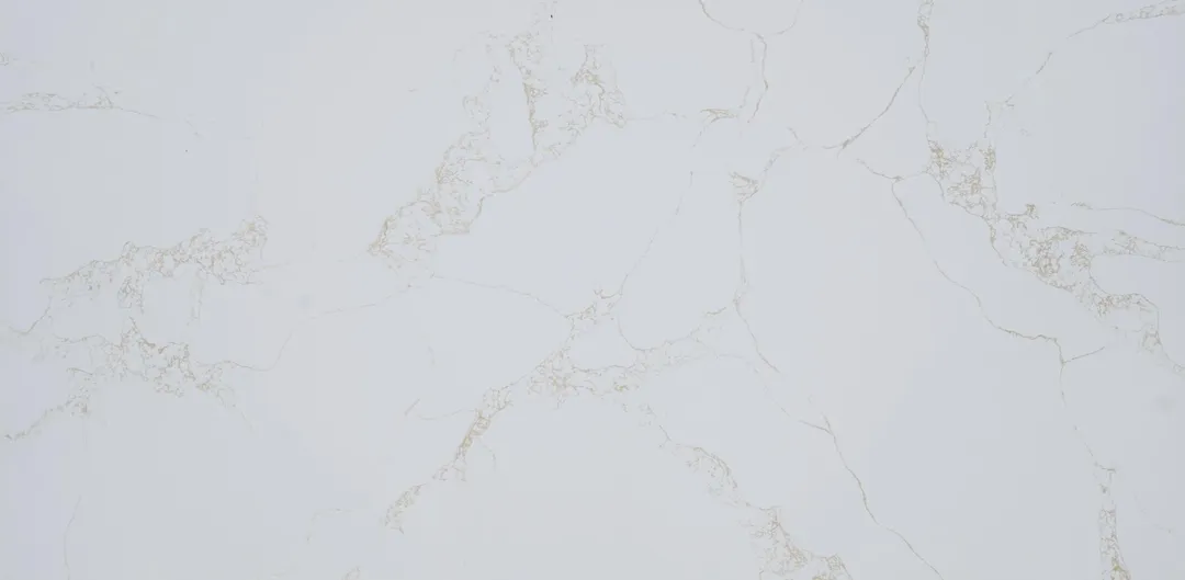 Calacatta Champagne quartz slab: fine champagne-gold threads and flecks on near-white