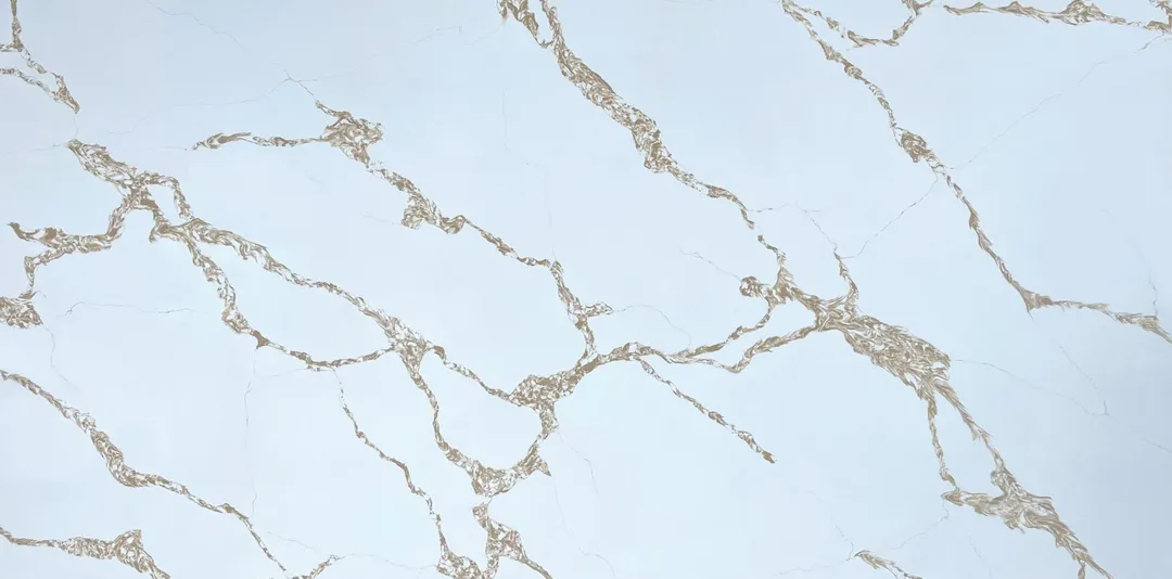 Calacatta Oro Fino quartz slab: lace-like gold and grey veins across cool white