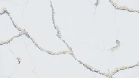 Calacatta Vagli quartz slab: winding beige veins with blue-grey edges on cool white