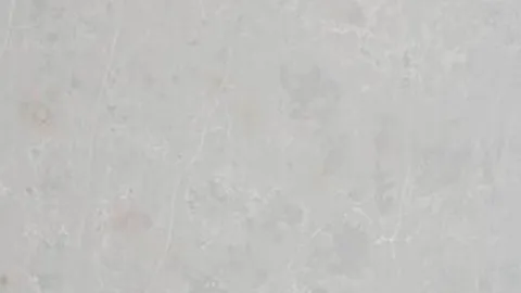 Cemento quartz slab: pale concrete grey with soft mottling and faint white hairlines