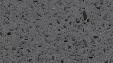 Ferro quartz slab: iron grey packed with black and smoky grey angular chips