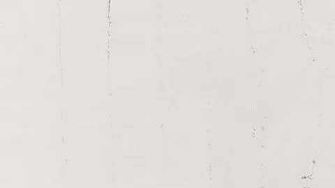 Gesso quartz slab: chalky off-white with a few fine near-vertical dark lines