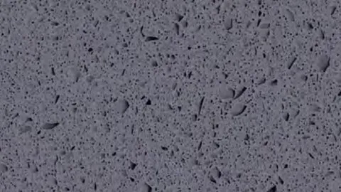 Grafite quartz slab: violet-tinged graphite grey with fine dark specks and slender shards