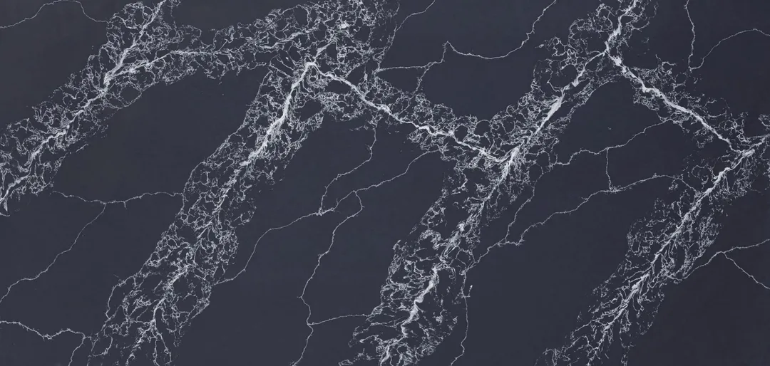 Nero Fulmine quartz slab: white web veining gathered in diagonal bands on black