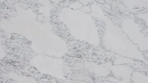 Nuvola quartz slab: folded grey ribbon veins wrapping rounded white patches
