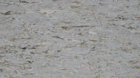 Oliva quartz slab: mid grey horizontal grain with caramel and dark brown streaks