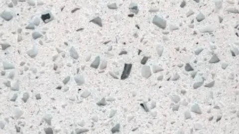 Vetro quartz slab: large angular glassy chips, clear and near-black, on pale grey-white