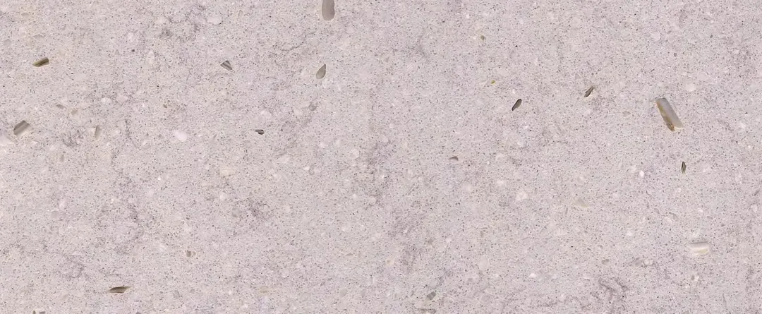 Calce terrazzo slab: pale lime-washed grey with a few fine chips