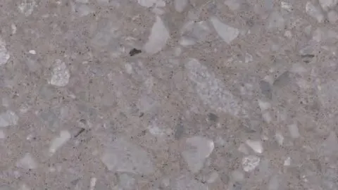 Tortora terrazzo: dove grey ground with large angular chips in paler and darker grey