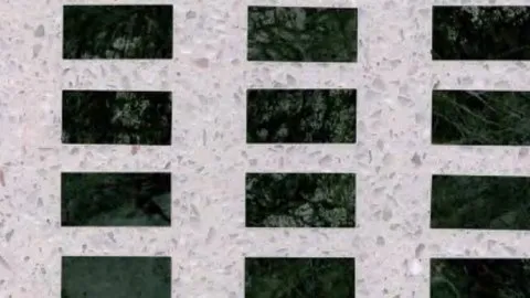 Verde Intarsio terrazzo: dark green veined stone rectangles inlaid in a pale terrazzo grid